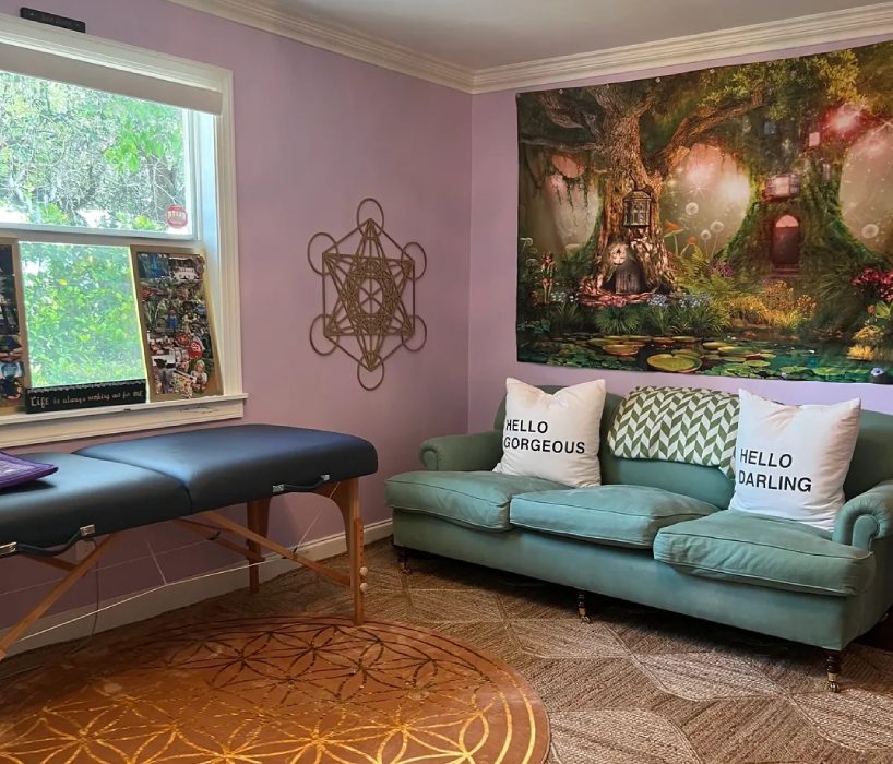 A couch and table in a room with a wall mural